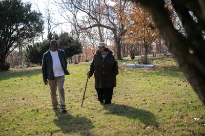 Harry and Janis Ivory walk through the cemetery where their parents are buried in Rendville, OH. Janis, her brother Harry and others are working to revitalize the old coal town.